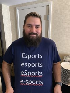 photo of Rishi Chadha wearing a tshirt with various spellings of esports